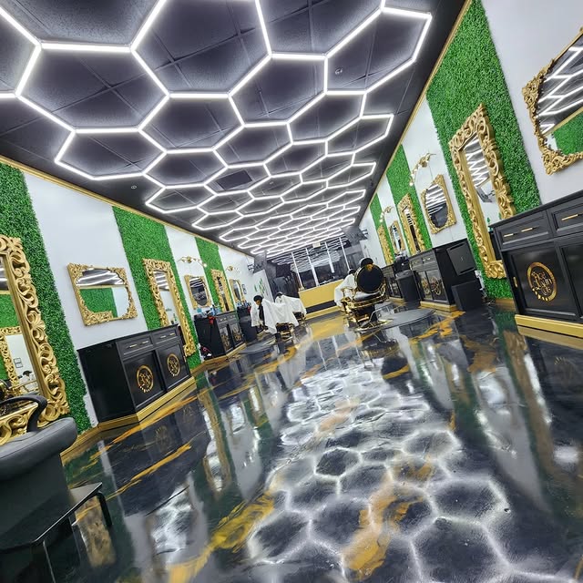 Inside High Quality Cuts — hexagon lit ceiling, gold mirrors and luxury barber chairs